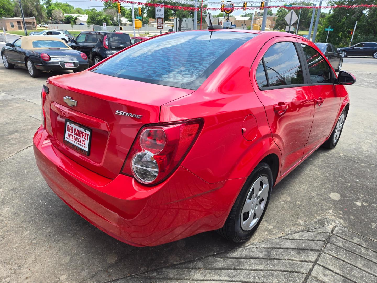 2015 Red /Black Chevrolet Sonic LS Auto Sedan (1G1JA5SH9F4) with an 1.8L L4 DOHC 24V engine, 6-Speed Automatic transmission, located at 503 West Court, Seguin, TX, 78155, (830) 379-3373, 29.568621, -97.969803 - Photo#2